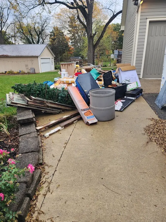Dumpster being loaded with debris for Estate Cleanout Dumpster Rental in Wyoming